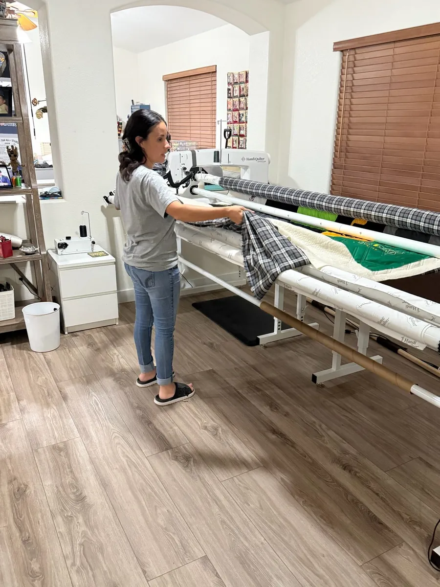 Me at my longarm, quilting a customer's top