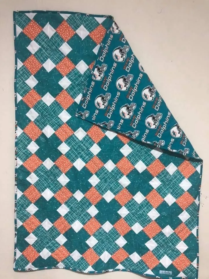 A teal and coral patchwork quilt