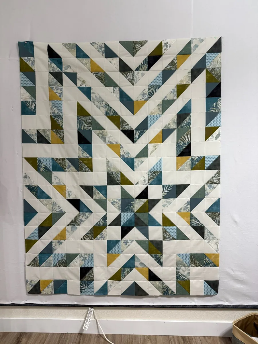 A custom star quilt in teal, gray and white